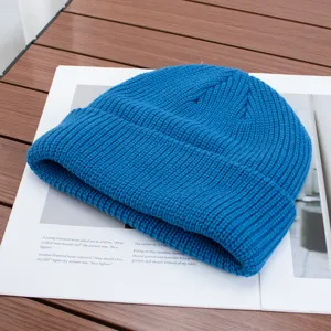 Blue knit beanie detail showing the soft ribbed texture and folded cuff design for winter.