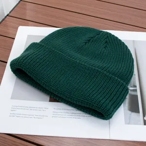 Solid dark green knitted beanie hat for autumn and winter, warm and stylish everyday cap.