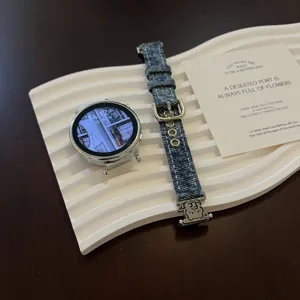 Denim smartwatch strap with cute cat metal charm, comfortable fabric replacement band for watch.