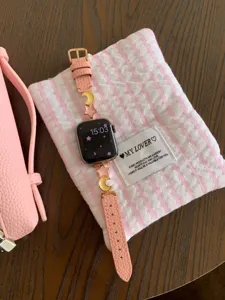 Pink lychee texture leather Apple Watch band featuring cute star and moon metal charms accessory.