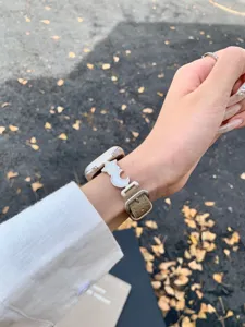 Detailed shot of the star and moon charm leather watch strap worn on wrist, chic design.