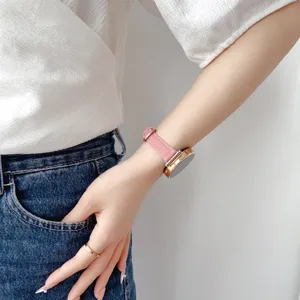 Close-up view of a pink denim smartwatch replacement strap worn gracefully on the wrist.