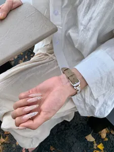 Stylish litchi pattern leather Apple watch strap featuring unique moon charm design.