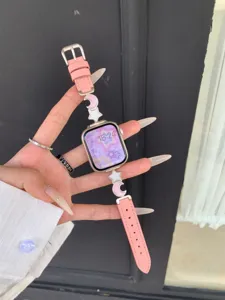 Pink leather Apple watch strap featuring cute star and moon charms, elegant detail view.