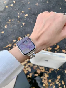 Litchi pattern leather watch strap with metal star moon charms for Apple Watch detail view.