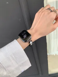 Close up of luxury leather metal watch strap with charming star pendant detail for smartwatch.