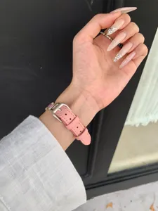 Pink litchi leather watch strap detail view, compatible with Apple Watch series, stylish accessory.