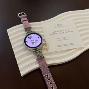 Detailed view of purple denim fabric smartwatch strap with cute metal bear charms and display.