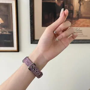 Purple denim fabric smart watch strap with metal eyelets detail view on wrist display