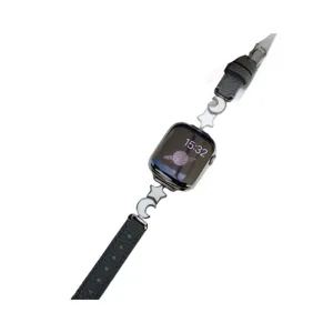 Black leather strap for Apple Watch with star and moon charms, stylish accessory band.