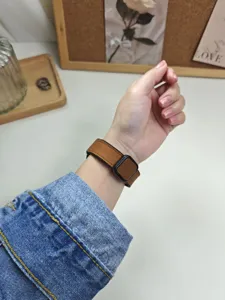 Vista dettagliata del cinturino per orologio in silicone, marrone con fibbia nera.