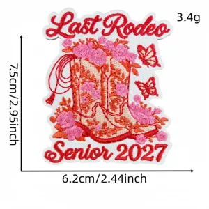 Detailed view of pink and red embroidered cowboy boot patch with floral and butterfly motifs.