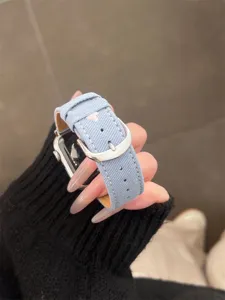 Denim watch band compatible with Apple Watch, featuring cute embroidery and secure metal buckle.