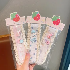 Detailed shot of children's cute lace Velcro hair bangs stickers with sweet pastel charms.