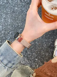 Close-up detail of stylish canvas and leather smartwatch strap worn on wrist, premium quality.