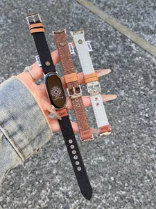 Canvas watch band detail shot showing texture, metal buckle and stitched branding tag clearly.