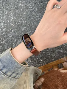 Detail shot of brown canvas leather replacement watch strap for smart bands, stylish and durable.