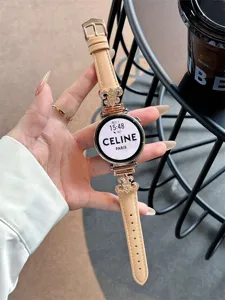 Detailed view of beige leather smartwatch strap with rose gold metal decorative charms.