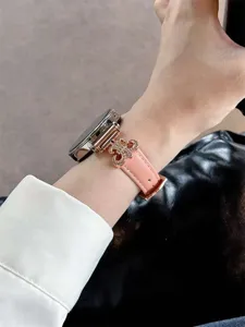 Pink leather smartwatch replacement band with rose gold metal cross charm detail wrist view