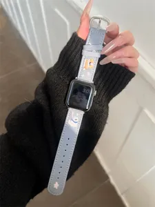 Detailed view of blue denim embroidered dog watch band compatible with Apple Watch, stylish accessory.