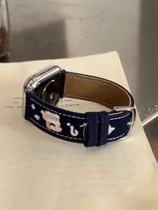 Denim embroidered puppy watch band compatible with Apple Watch Series, stylish detail view.
