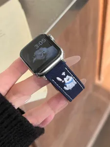 Denim embroidered puppy watch band compatible with Apple Watch, stylish and durable strap detail.