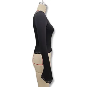 Side view detail of black long-sleeve slim top with delicate lace trim on cuffs and hem.