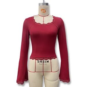 Detail view of wine red long sleeve top featuring delicate lace trim and elegant bell sleeves.