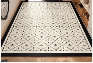 Detail shot of black and white geometric PVC floor mat in entryway, waterproof and easy clean.