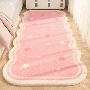 Pink fluffy bedside runner rug, cute wavy edge aesthetic soft carpet for bedroom floor and home.