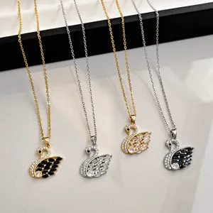 Detailed view of sparkling crystal swan pendant necklaces featuring elegant pave stones.