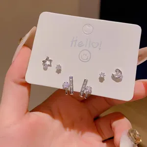 Silver cubic zirconia star moon stud earrings detail close up fashionable jewelry set