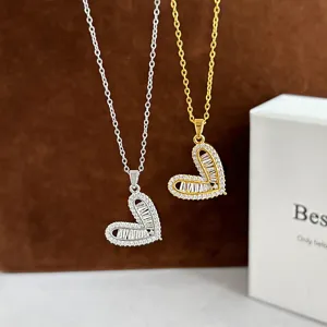 Detailed shot of Korean style asymmetric heart zirconia pendant necklaces in silver and gold.