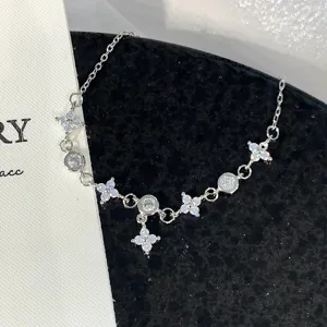 Silver-tone clover zircon detail bracelet, elegant and delicate wrist jewelry accessory.