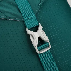 Backpack detail shot showing durable green ripstop fabric strap and grey plastic buckle