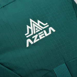 Close-up view of brand logo and durable ripstop fabric on the professional backpack.