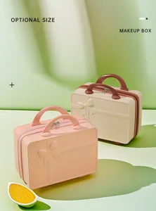 Detailed view of the portable mini hard shell makeup box with bow design and sturdy handle.