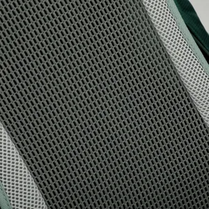 Close-up detail of breathable mesh fabric on hiking backpack, showing durable texture.