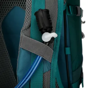 Detail view of hiking backpack shoulder strap with hydration tube clip and valve.