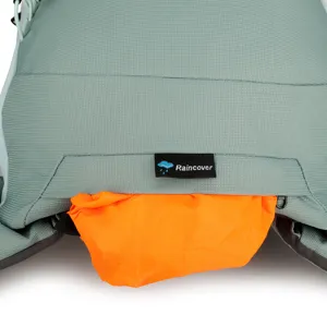 Close-up detail of the backpack showing the orange rain cover and functional label.