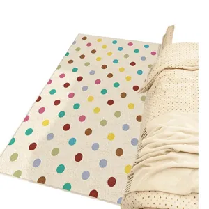 Detail view of soft cashmere-like rug with colorful polka dots, perfect cozy bedside decor.
