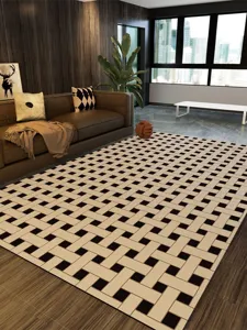 Detail view of a modern geometric PVC wipeable living room rug with a woven black and beige pattern.