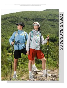 Outdoor hiking backpack detail view in natural mountain scene with trekking poles and gear.