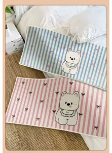 Cozy striped bedside rug detail featuring cute white bear and bow prints for bedroom decor.