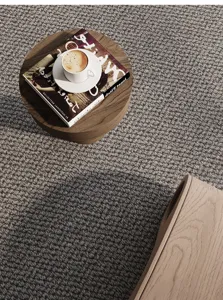 Grey faux sisal loop pile carpet detail, textured woven floor mat for living room home decor.