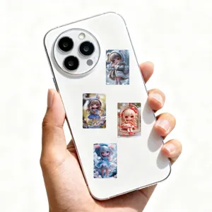 Detail shot of cute AI doll graffiti stickers applied on white smartphone back.
