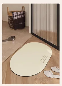 Primo piano del tappetino da bagno ovale in terra di diatomee beige con stampa di gatto.