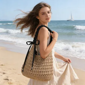 Casual woven straw shoulder bag with black strap and bow decoration for beach vacation style.