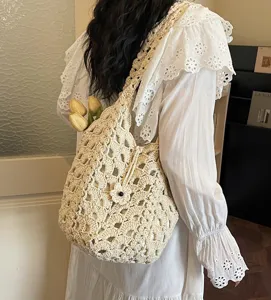 Chic handmade crochet shoulder bag with hollow-out design, elegant beige knit tote for daily wear.