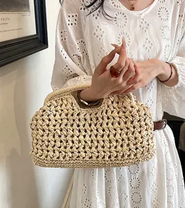 Woven straw clutch bag for women, retro shell design handbag, casual beach straw purse detail.